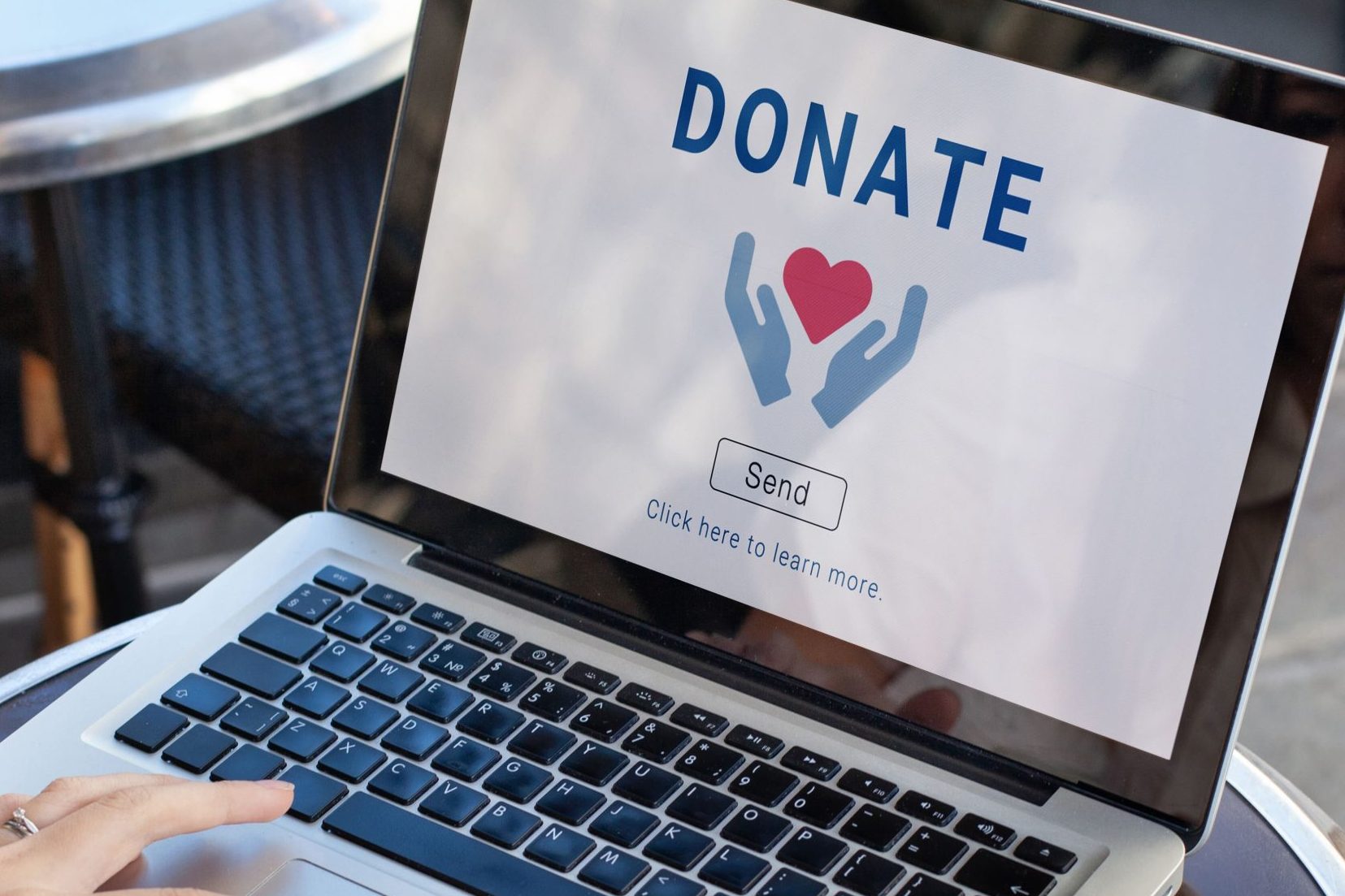 A laptop with the words "Donate" on the screen